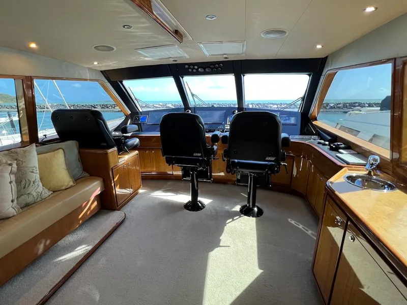 Slide: The Image of Interior helm of 2004 Bertram 670 yacht with panoramic windows and dual captain chairs. - 47