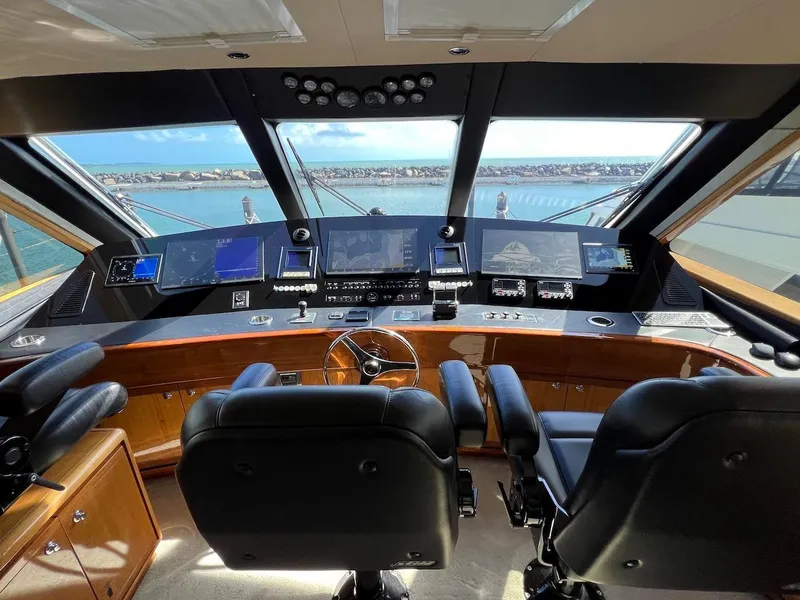 Slide: The Image of Bertram 670 yacht cockpit, 2004 model, featuring advanced navigation systems and luxurious seating. - 48