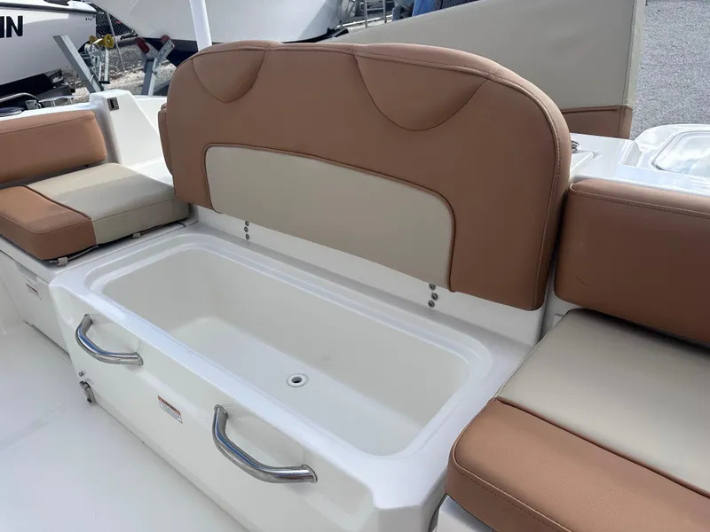 Slide: The Image of NauticStar 222L Offshore 2024 boat seating with storage compartment and cushioned backrest. - 10
