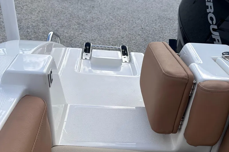 Slide: The Image of 2024 NauticStar 222L Offshore boat with cushioned seating and swim platform. - 11