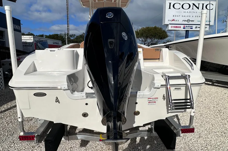 Slide: The Image of 2024 NauticStar 222L Offshore boat with outboard motor and swim ladder. - 14