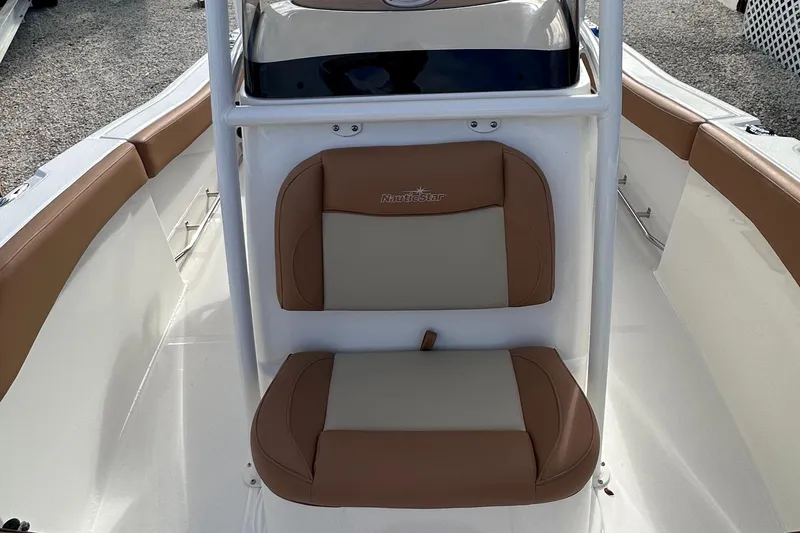 Slide: The Image of 2024 NauticStar 222L Offshore boat seating with tan and beige cushions. - 2