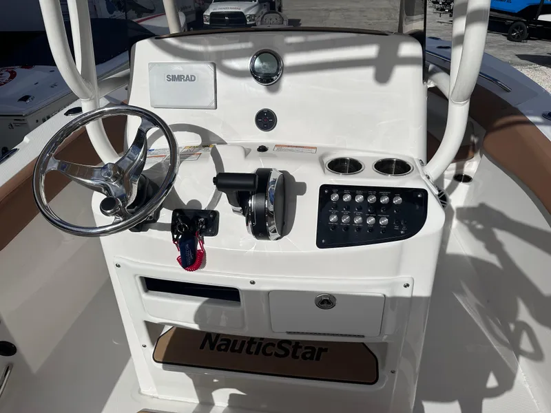 Slide: The Image of 2024 NauticStar 222L Offshore boat console with steering wheel and control panel. - 4