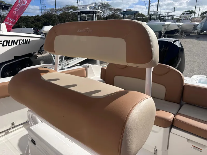 Slide: The Image of 2024 NauticStar 222L Offshore boat with tan and white seating. - 5