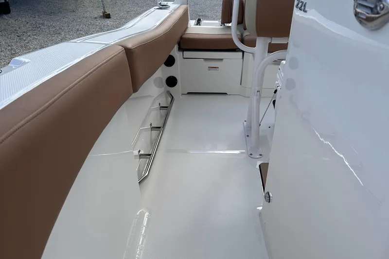 Slide: The Image of 2024 NauticStar 222L Offshore boat interior with tan seating and white deck. - 6