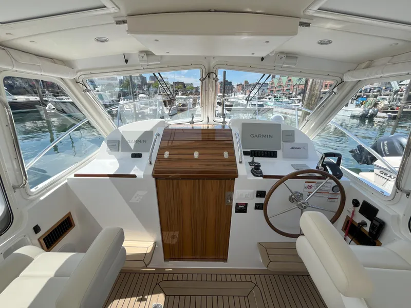 Slide: The Image of 2024 MJM 35 boat helm with Garmin navigation system, docked at marina. - 12