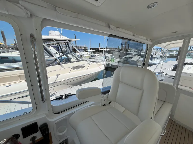 Slide: The Image of Interior view of 2024 MJM 35 yacht with white leather seating at marina. - 14