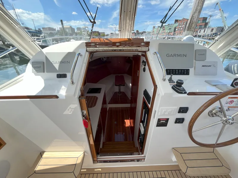 Slide: The Image of 2024 MJM 35 boat cockpit with Garmin navigation system and wooden interior. - 15