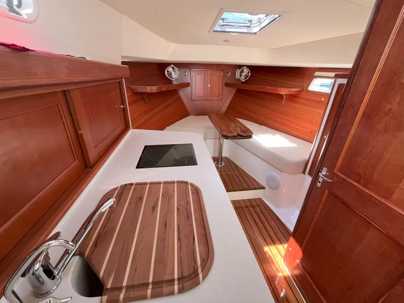Slide: The Image of 2024 MJM 35 yacht interior with wooden cabinetry and modern amenities. - 17