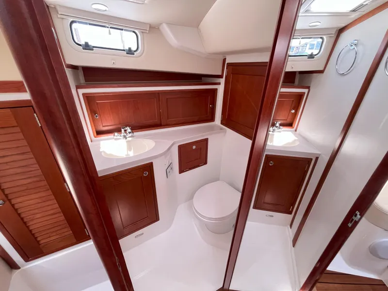 Slide: The Image of 2024 MJM 35 yacht bathroom with wooden cabinetry and modern fixtures. - 18