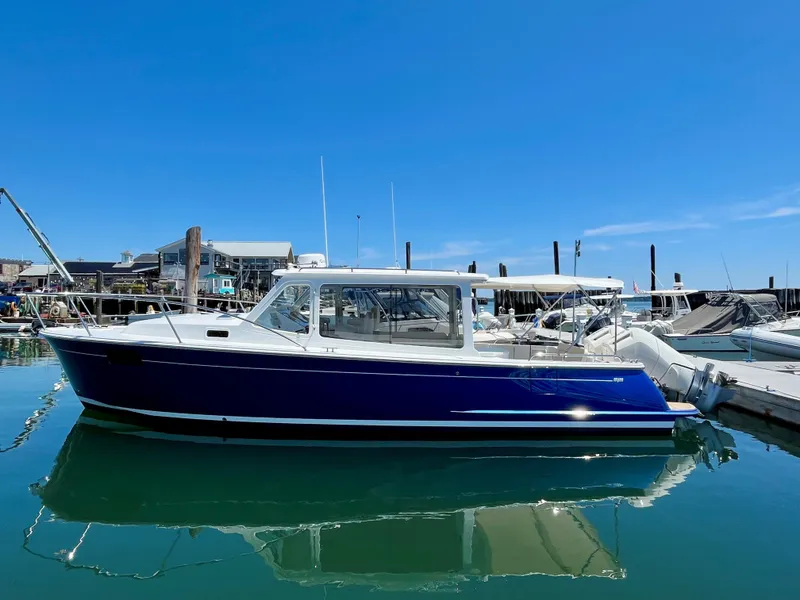 Slide: The Image of 2024 MJM 35 boat docked in a marina on a sunny day. - 2