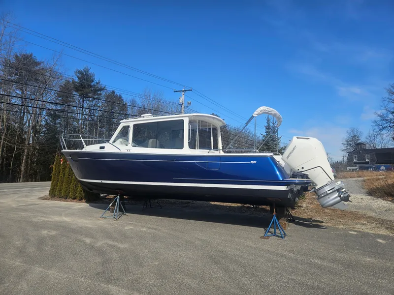 Slide: The Image of 2024 MJM 35 boat on stands in a parking lot. - 21