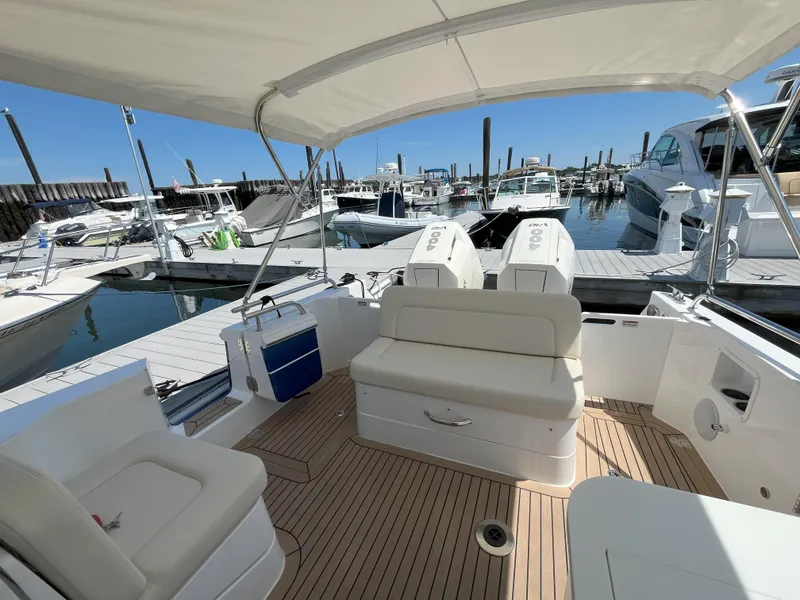Slide: The Image of 2024 MJM 35 boat interior at marina, featuring comfortable seating and modern design. - 6