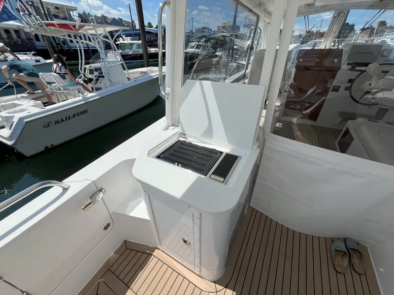 Slide: The Image of 2024 MJM 35 boat with outdoor grill station and teak flooring. - 8