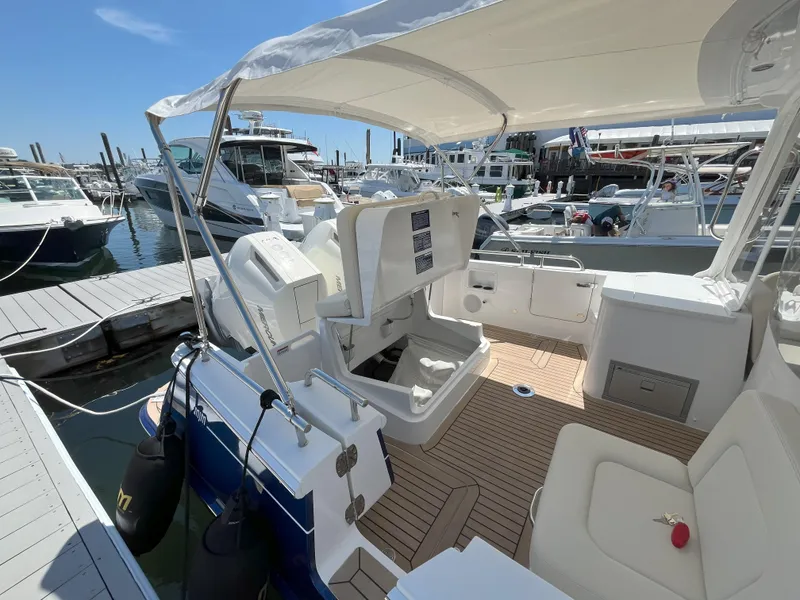 Slide: The Image of 2024 MJM 35 boat interior at marina, featuring seating and helm station. - 9