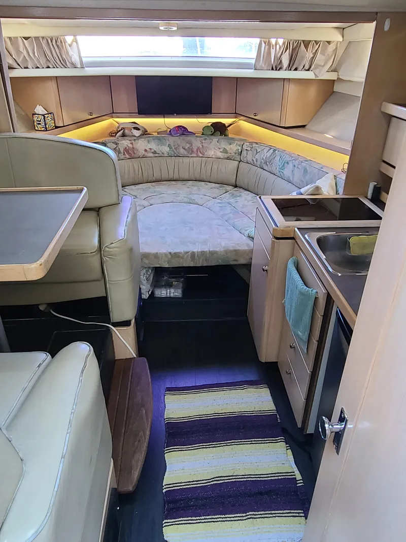 Slide: The Image of Interior of a 1995 Bayliner Avanti boat with seating and kitchenette. - 10
