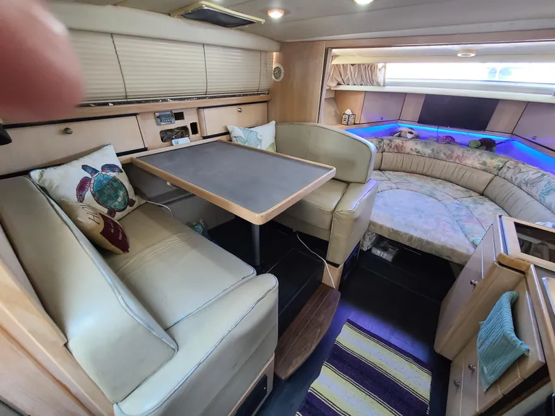 Slide: The Image of 1995 Bayliner Avanti interior with dining area and cozy seating. - 11