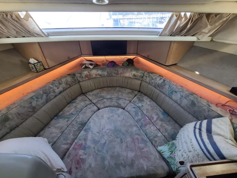 Slide: The Image of Interior cabin of a 1995 Bayliner Avanti boat with cushioned seating. - 14