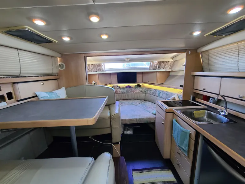 Slide: The Image of Interior of 1995 Bayliner Avanti boat with dining area, kitchenette, and sleeping quarters. - 19