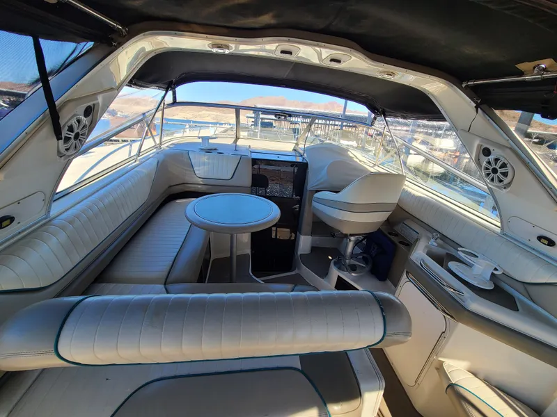 Slide: The Image of Interior of 1995 Bayliner Avanti boat with seating, table, and helm station. - 4