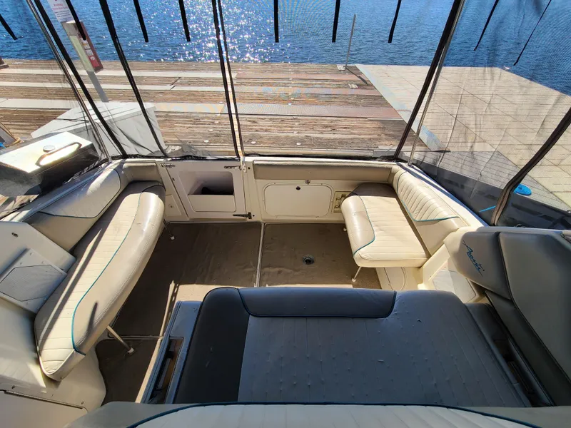 Slide: The Image of 1995 Bayliner Avanti boat interior with seating and dock view. - 6