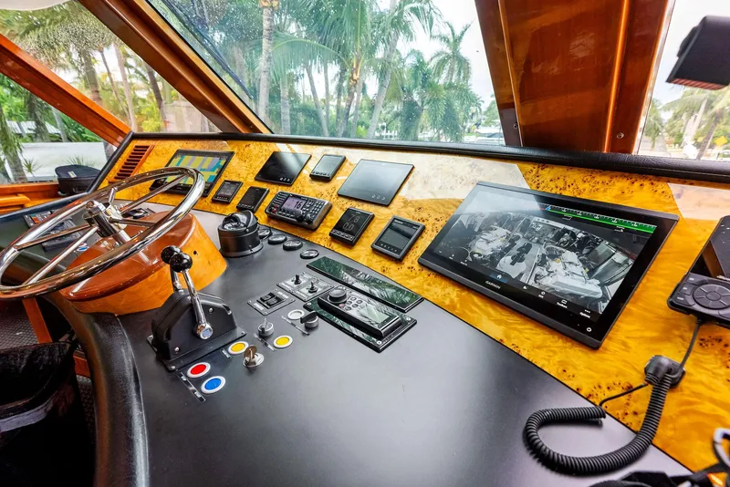 Slide: The Image of Monte Fino 82 yacht helm, 1999 model, featuring advanced navigation controls and screens. - 12