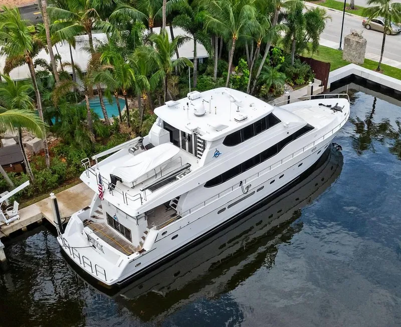 Slide: The Image of Monte Fino 82 yacht, 1999 model, docked near palm trees. - 2