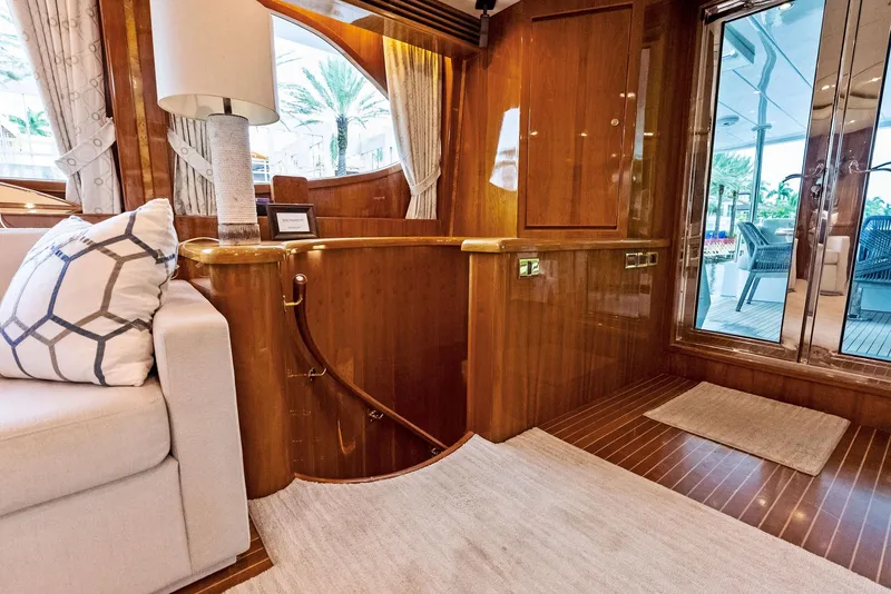 Slide: The Image of Luxurious interior of 1999 Monte Fino 82 yacht with elegant wood finishes and cozy seating. - 25