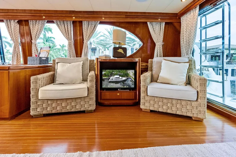 Slide: The Image of Luxurious Monte Fino 82 yacht interior with wicker chairs and elegant wood paneling, 1999 model. - 26