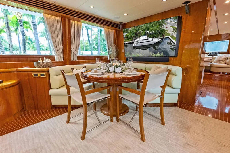 Slide: The Image of Luxurious dining area on 1999 Monte Fino 82 yacht with elegant decor and large windows. - 28