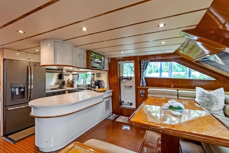 Slide: The Image of Luxurious Monte Fino 82 yacht interior, featuring modern kitchen and elegant dining area, 1999 model. - 30