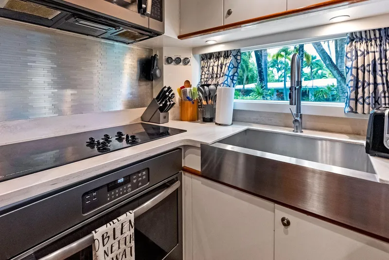 Slide: The Image of Modern kitchen in 1999 Monte Fino 82 yacht with stainless steel appliances and window view. - 35