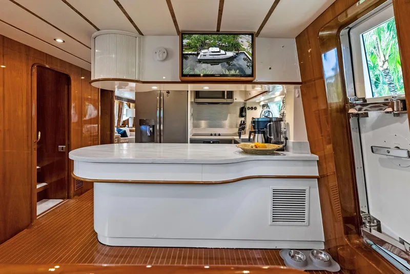 Slide: The Image of Luxurious Monte Fino 82 yacht interior, featuring modern kitchen and elegant wood finishes, 1999 model. - 37