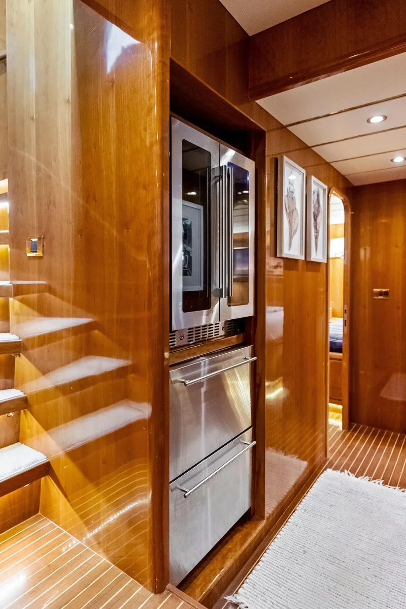 Slide: The Image of Luxurious interior of 1999 Monte Fino 82 yacht with modern wood paneling and stainless steel appliances. - 42