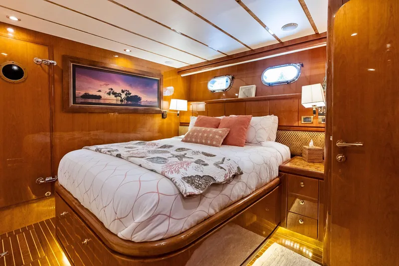 Slide: The Image of Luxurious bedroom interior of 1999 Monte Fino 82 yacht with elegant wood paneling. - 44