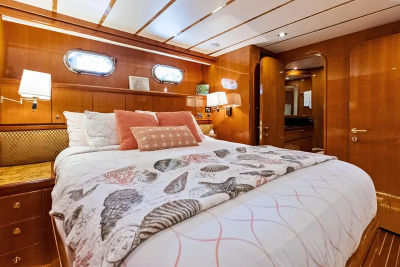 Slide: The Image of Luxurious bedroom interior of 1999 Monte Fino 82 yacht with elegant wood paneling. - 45