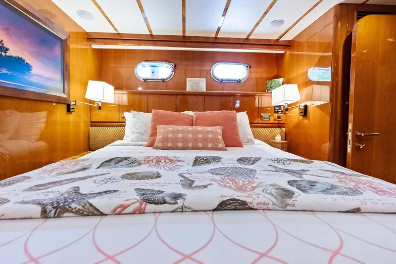 Slide: The Image of Luxurious bedroom interior of 1999 Monte Fino 82 yacht with elegant bedding and warm lighting. - 46