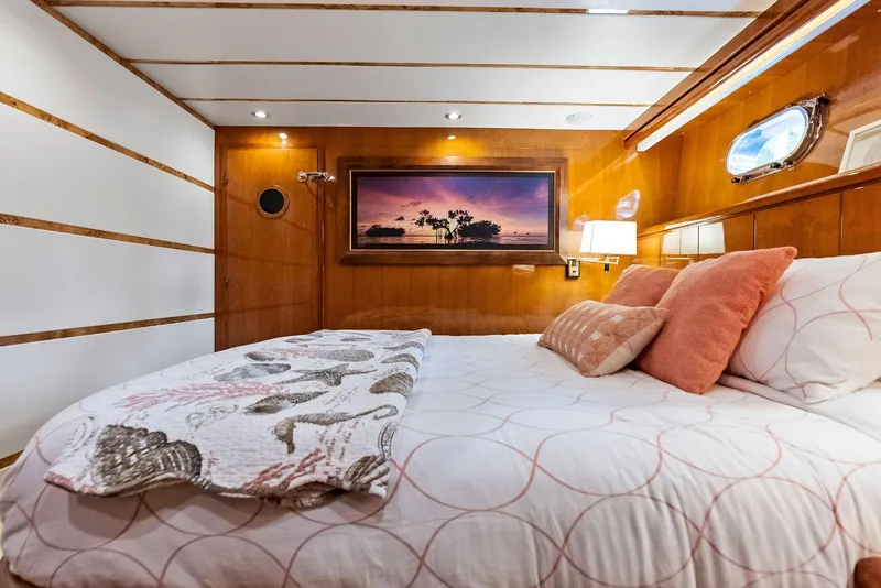 Slide: The Image of Luxurious Monte Fino 82 yacht bedroom, 1999 model, with elegant wood paneling and cozy bedding. - 48
