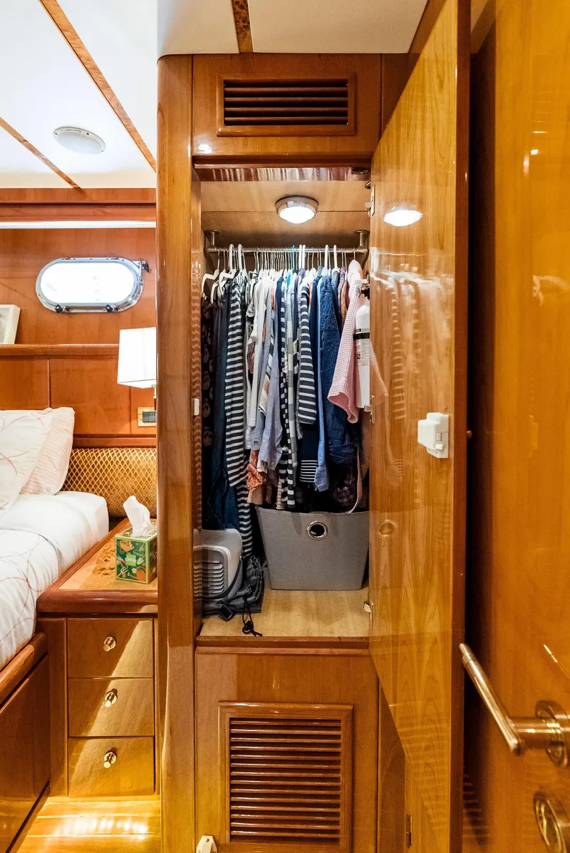 Slide: The Image of Wooden closet with clothes inside Monte Fino 82 yacht, 1999 model. - 49