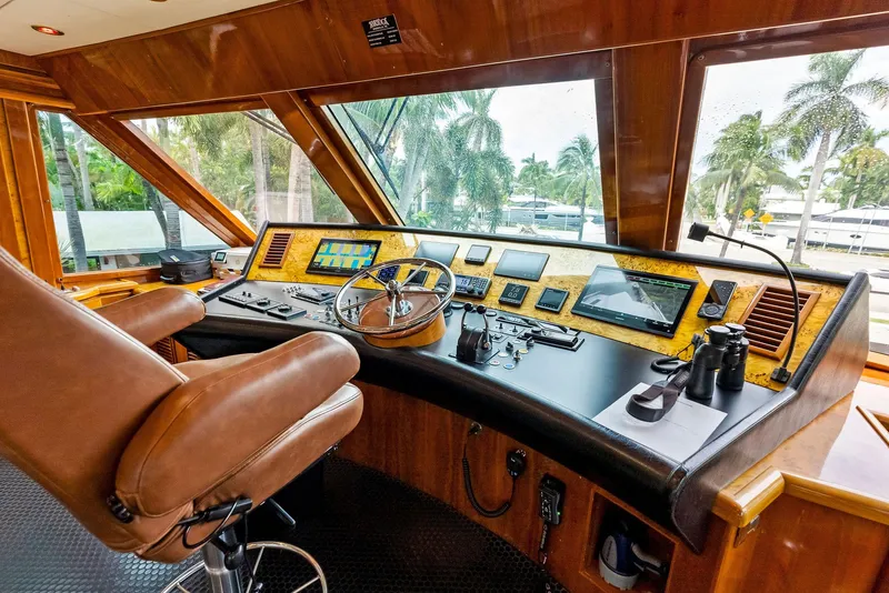 Slide: The Image of Luxurious 1999 Monte Fino 82 yacht helm with advanced navigation controls and leather seating. - 9