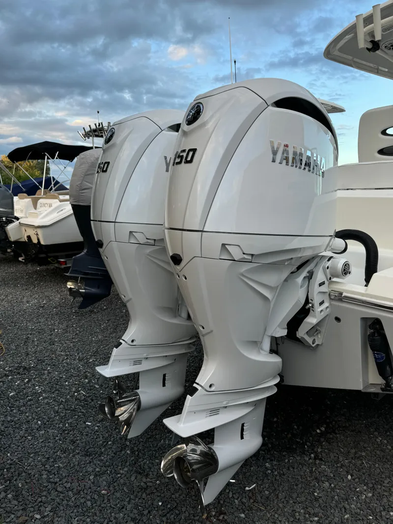 Slide: The Image of 2024 Cobia 240 Center Console with twin Yamaha 250 outboard engines. - 18