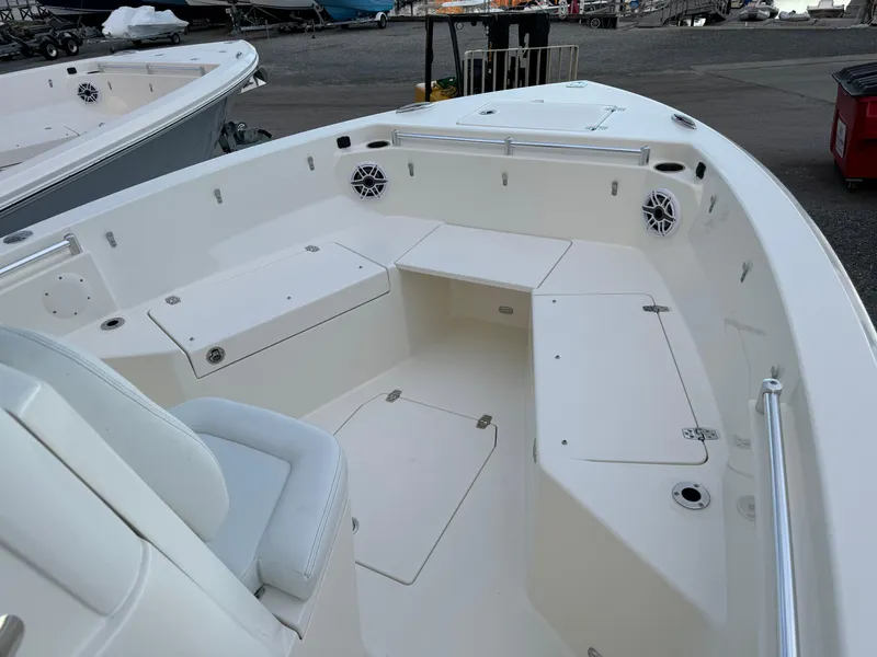 Slide: The Image of 2024 Cobia 240 Center Console boat interior with seating and storage compartments. - 19