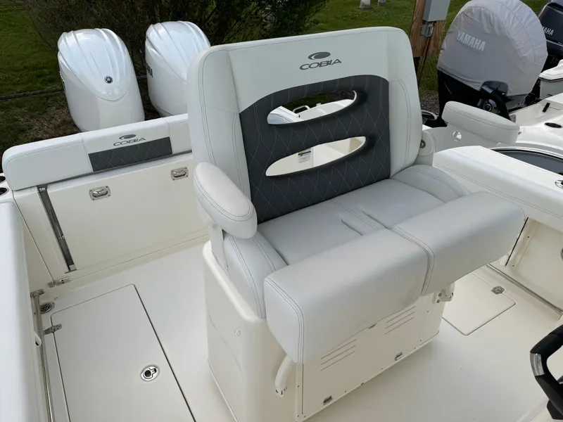 Slide: The Image of 2024 Cobia 240 Center Console boat with dual engines and cushioned seating. - 22