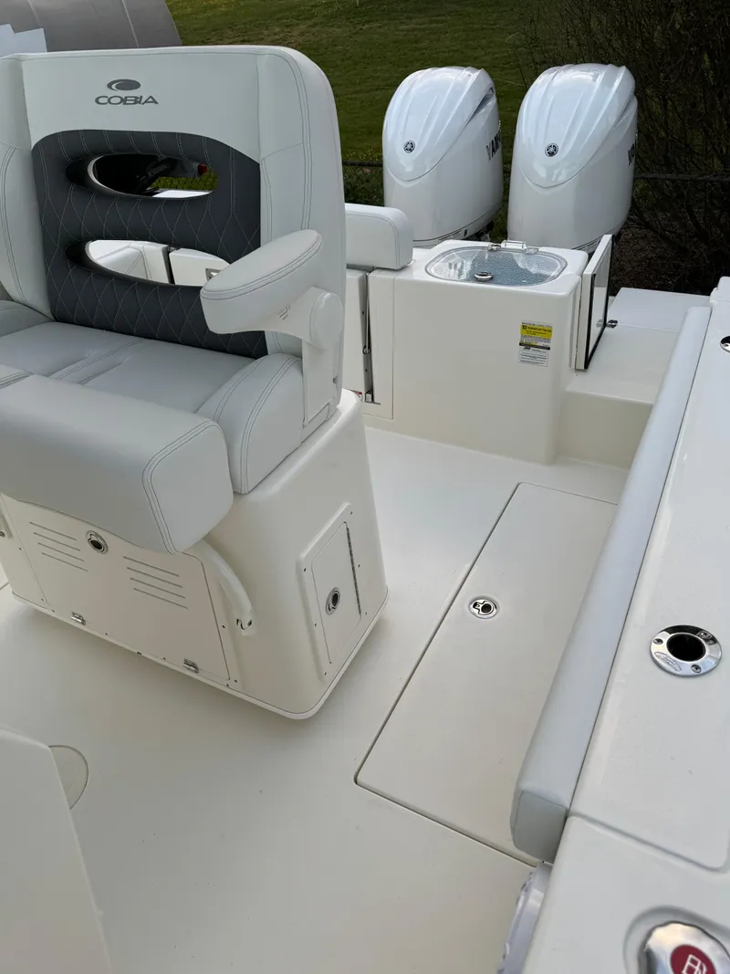 Slide: The Image of 2024 Cobia 240 Center Console boat interior with dual engines. - 23