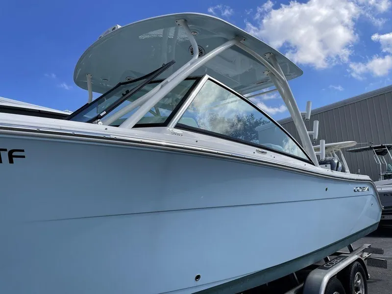 Slide: The Image of 2022 Cobia 280 DC boat with hardtop and sleek design. - 11