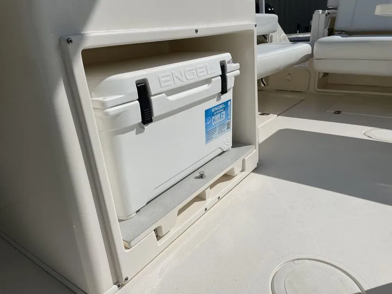 Slide: The Image of Built-in cooler storage on 2022 Cobia 280 DC boat. - 12