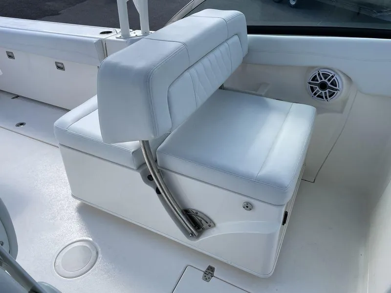 Slide: The Image of 2022 Cobia 280 DC boat with white cushioned seating and built-in speaker. - 15
