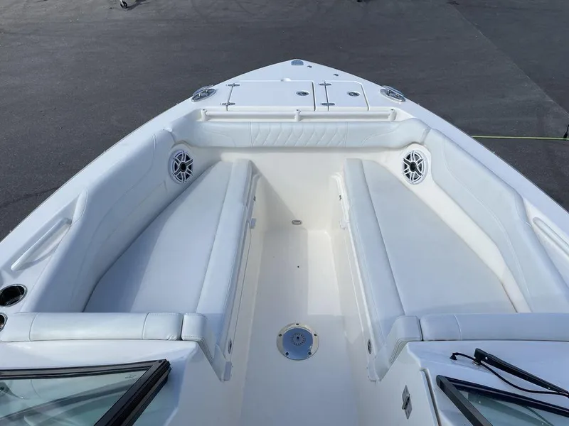 Slide: The Image of 2022 Cobia 280 DC boat bow seating area with white upholstery. - 18