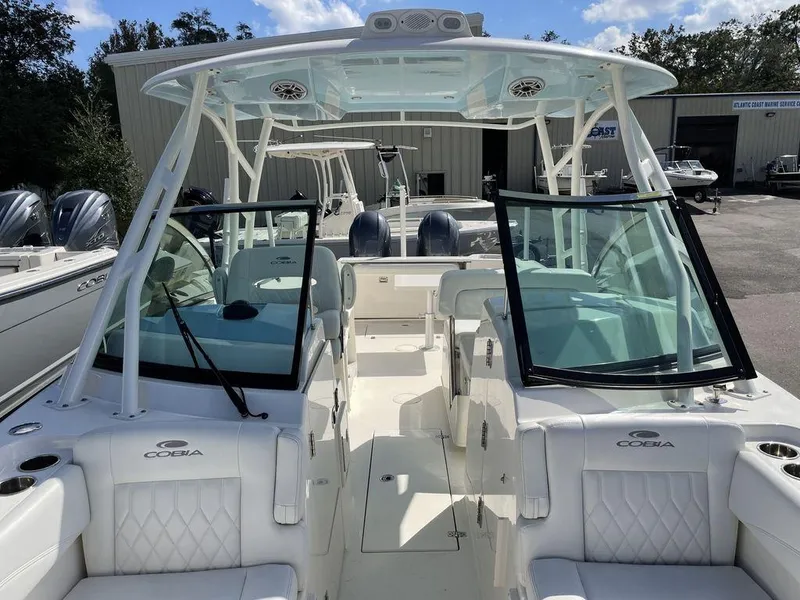 Slide: The Image of 2022 Cobia 280 DC boat with dual consoles and spacious seating. - 6