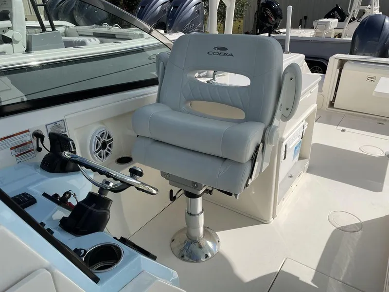 Slide: The Image of Captain's chair and helm of a 2022 Cobia 280 DC boat. - 8